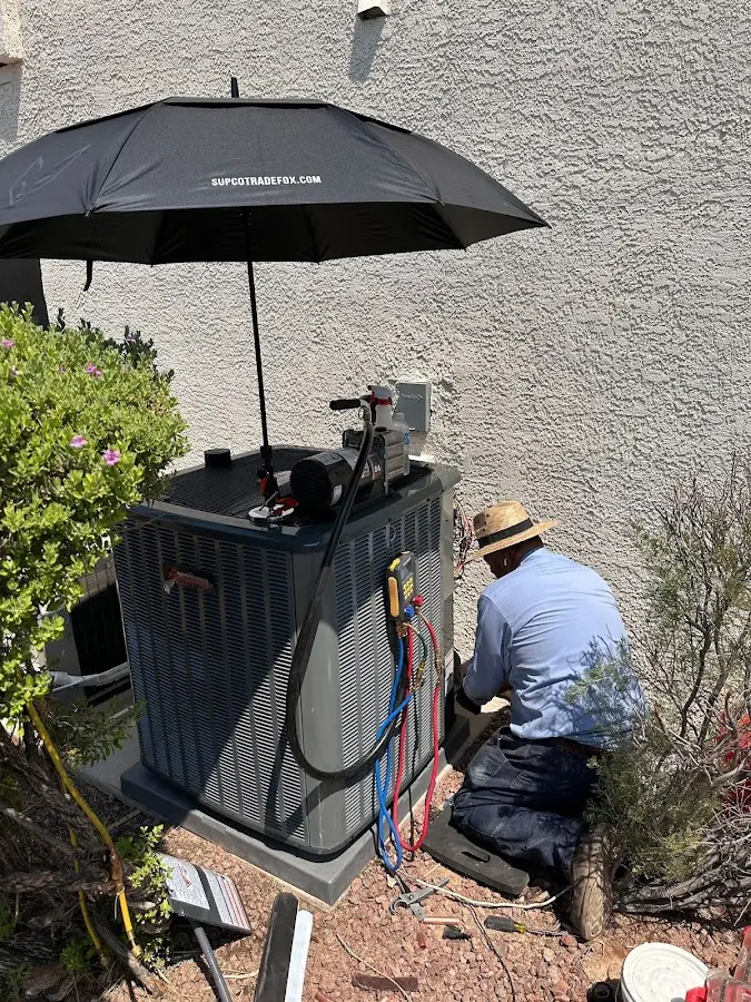 HVAC technician performing outdoor AC maintenance in Calipatria