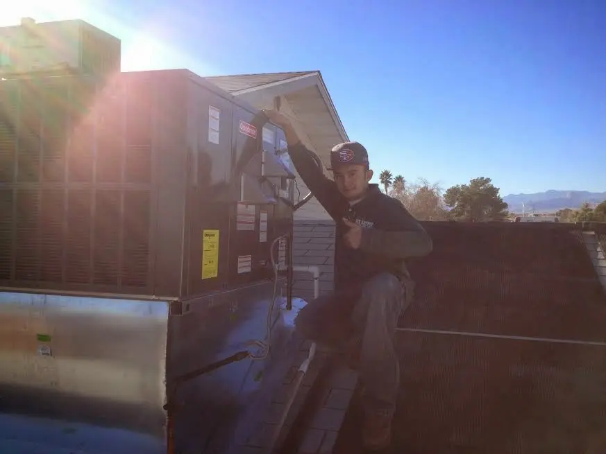 HVAC technician performing HVAC Inspection on a rooftop unit in Calipatria